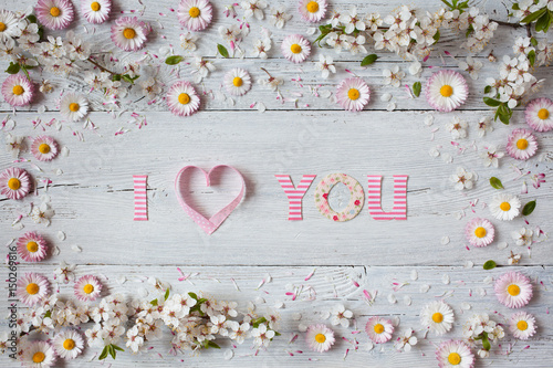 Background with daisies, cherry blossoms and declaration of love, text