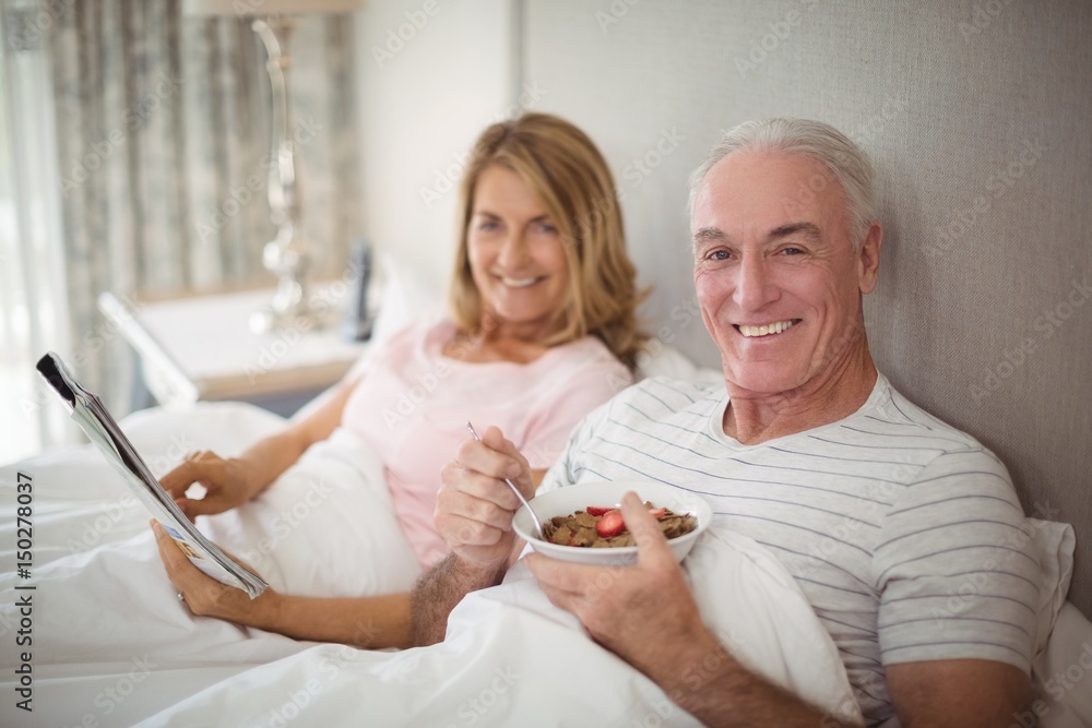 Portrait of smiling couple reading newspaper Portrait of smiling couple reading newspaper