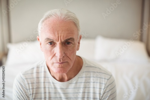 Portrait of senior man in bedroom