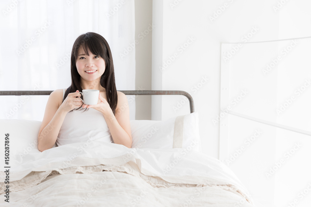 attractive asian woman relaxing in bedroom attractive asian woman relaxing in bedroom