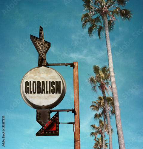 aged and worn vintage photo of globalism sign with palm trees