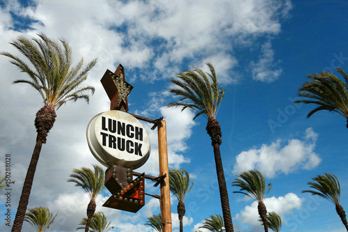 aged and worn vintage photo lunch truck sign with palm trees