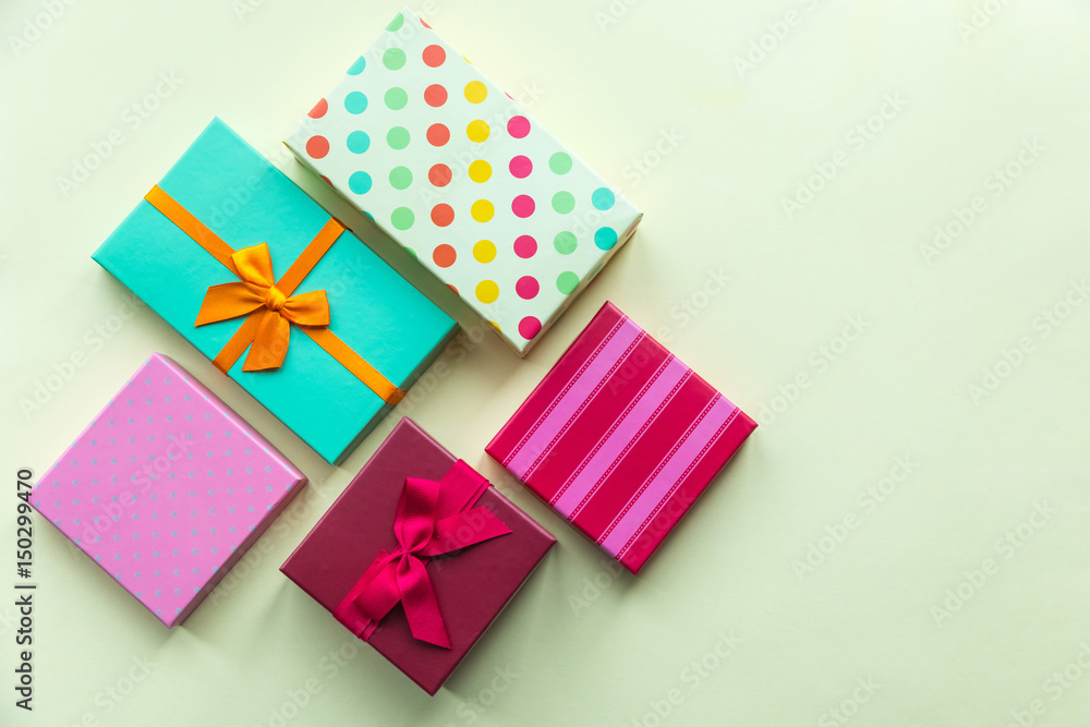 Holidays giftboxes on the pastel yellow background for mother's day, birthday, valentines day Holidays giftboxes on the pastel yellow background for mother's day, birthday, valentines day