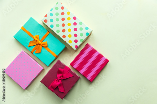 Holidays giftboxes on the pastel yellow background for mother's day, birthday, valentines day 