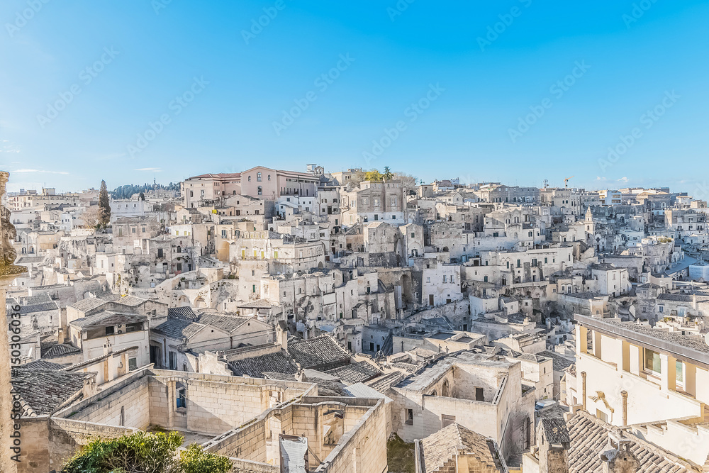 Obraz premium panoramic view of typical stones (Sassi di Matera) near gravina of Matera UNESCO European Capital of Culture 2019 on blue sky