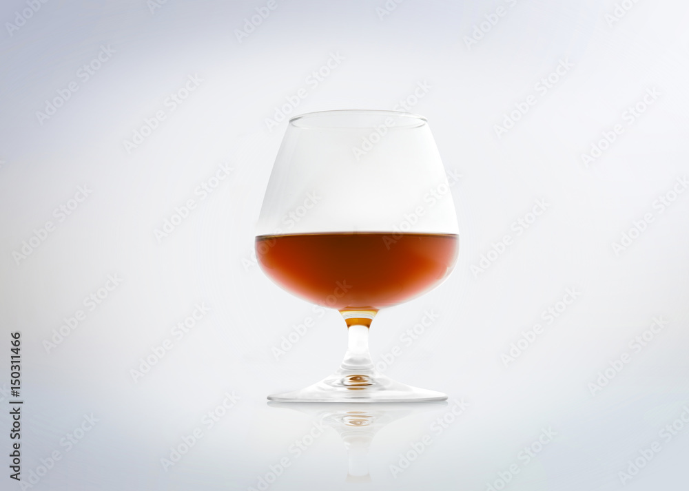 Glass of a french cognac brandy. Isolated on white background. Glass of a french cognac brandy. Isolated on white background.