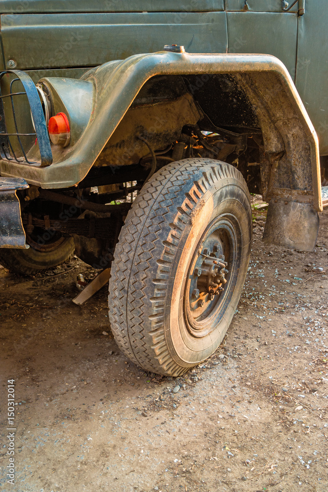 Detail of a soviet military truck vehicle tire over ground road