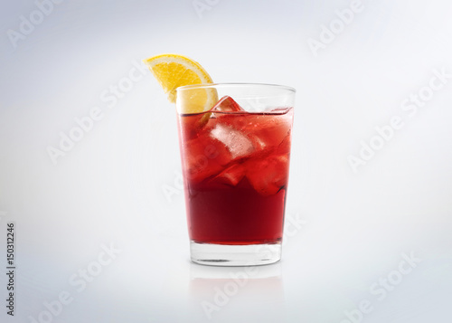 Negroni cocktail drink with ice cubes and orange. A glass with Campari (bitter). Isolated on white background. 