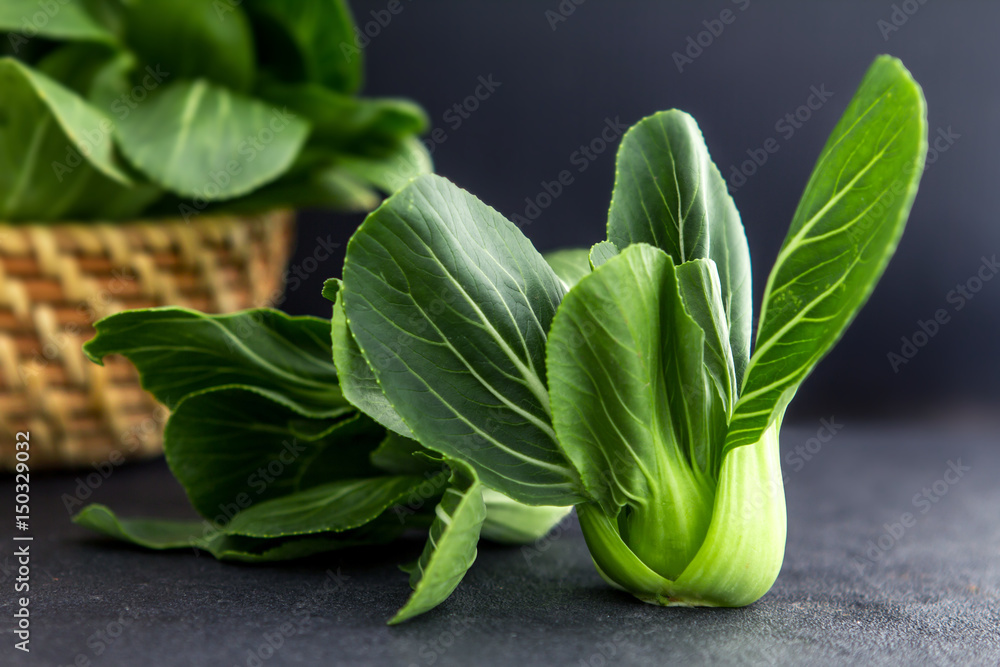 close up Fresh baby green bok choy on the black background , overhead or top view shot