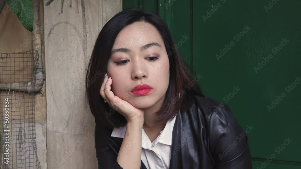 thoughtful upset Young Chinese woman - outdoor thoughtful upset Young Chinese woman - outdoor