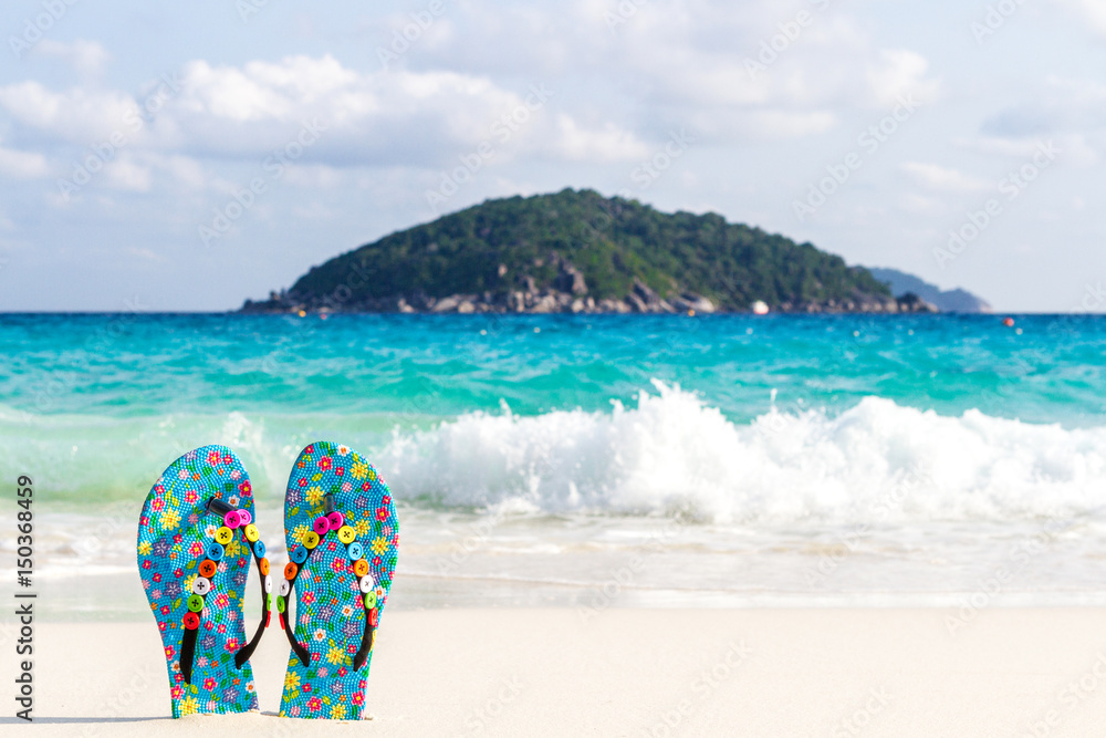 Summer vacation concept. Flip flops on a sandy ocean beach Thailand, Similan Islands. Summer vacation concept. Flip flops on a sandy ocean beach Thailand, Similan Islands.