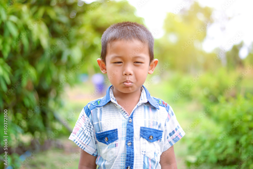 Portrait of young boy in nature, park or outdoors. cute kid outdoor. a child is smiling enjoying adopted life. Portrait of young boy in nature, park or outdoors. cute kid outdoor. a child is smiling enjoying adopted life.