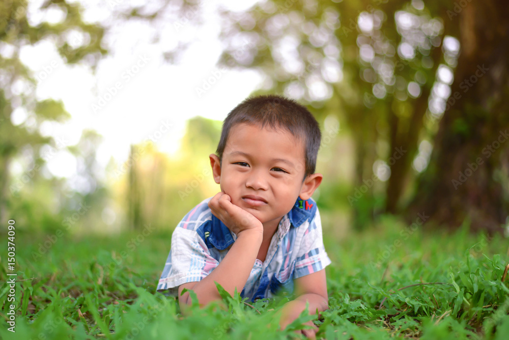 Portrait of young boy in nature, park or outdoors. cute kid outdoor. a child is smiling enjoying adopted life. Portrait of young boy in nature, park or outdoors. cute kid outdoor. a child is smiling enjoying adopted life.