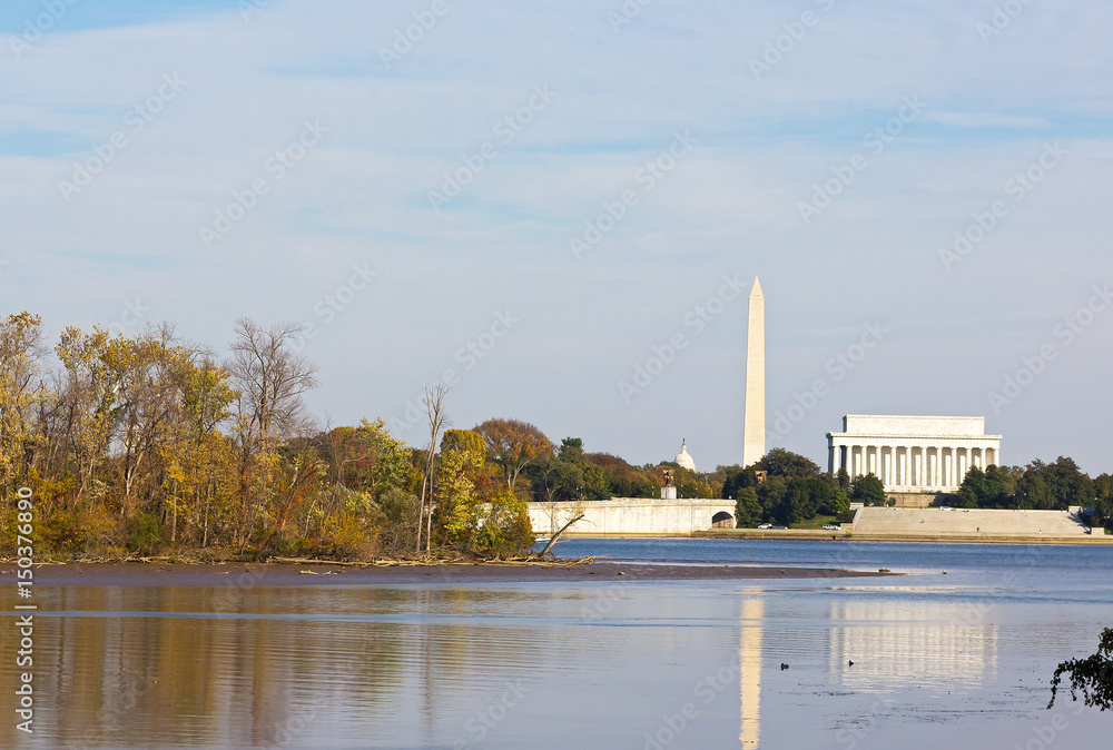 Washington DC landmarks in autumn. US capital monuments with reflection in Potomac River in fall.