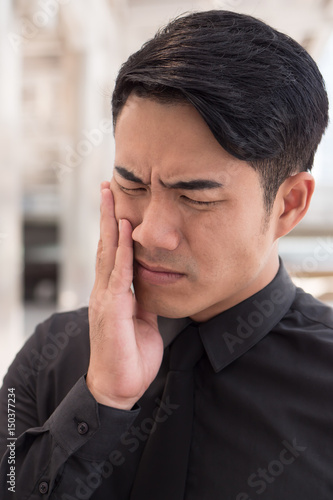 man suffering from toothache, oral problem