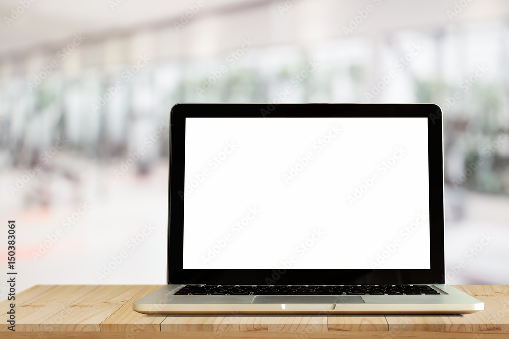Laptop on wood table space platform and fitness gym background. Blank screen Laptop for graphic display montage. Laptop on wood table space platform and fitness gym background. Blank screen Laptop for graphic display montage.
