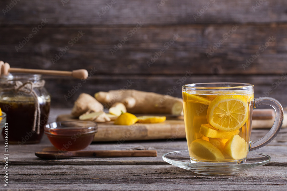 Ginger tea and ingredients on a grunge wooden background Ginger tea and ingredients on a grunge wooden background