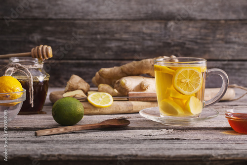  Ginger tea and ingredients on a grunge wooden background