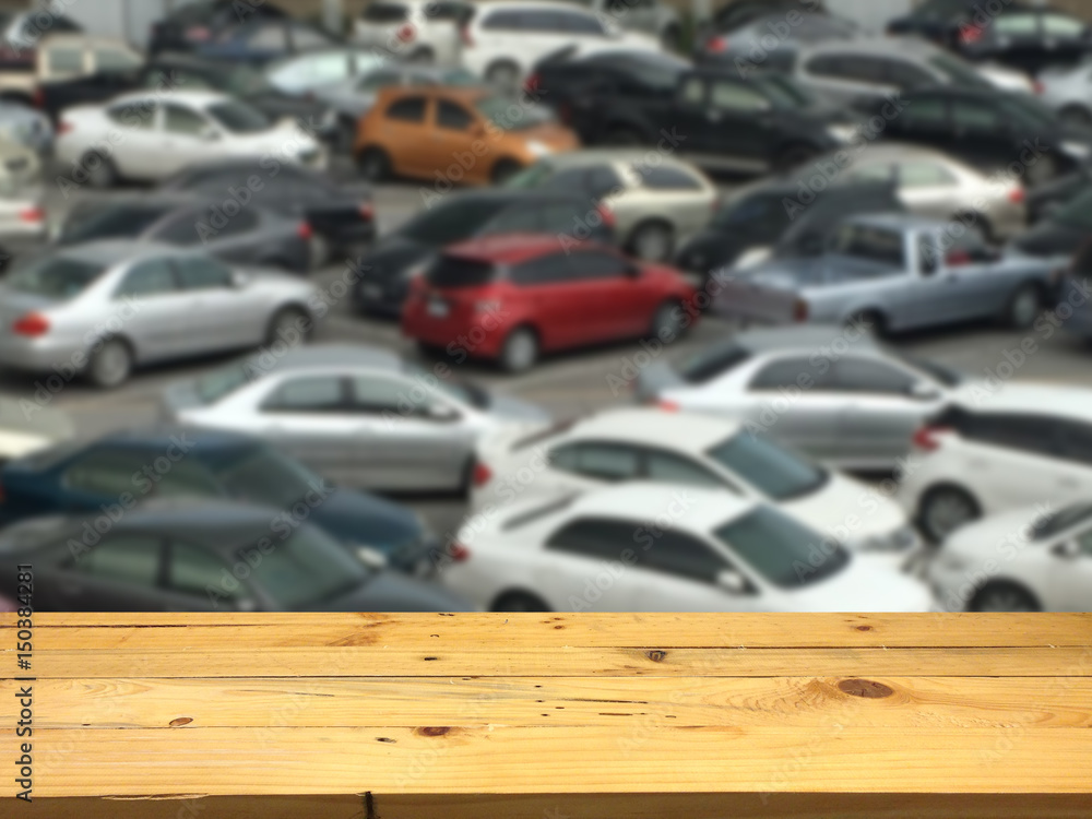 Empty wooden table space platform and blurred outdoor parking lot full of cars background for product display