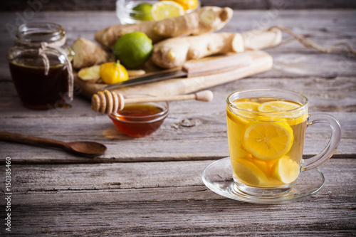  Ginger tea and ingredients on a grunge wooden background