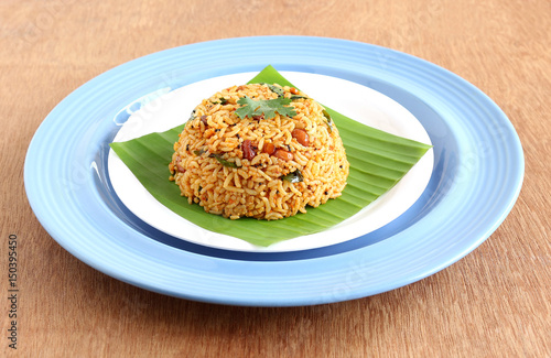 South Indian traditional vegetarian rice dish, puliyogare, made from rice and a paste containing tamarind and other ingredients.