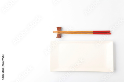 Empty plate and chopsticks on white Background