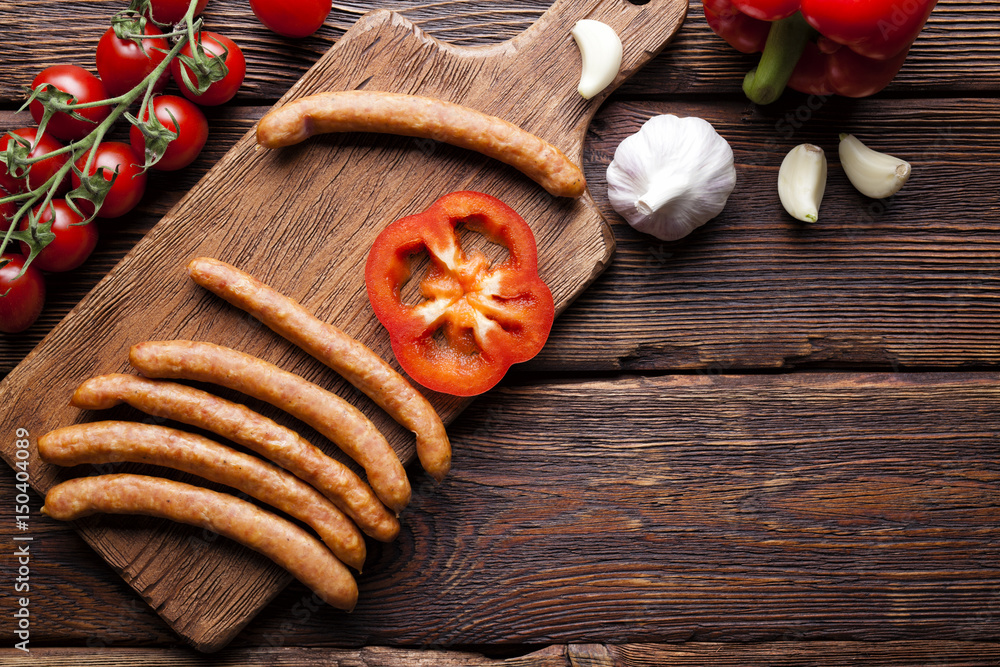 Sausage and vegetables on wooden table
