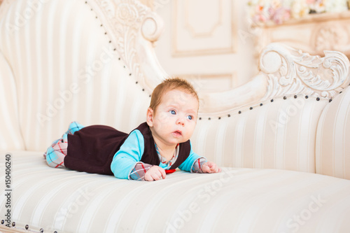 Portrait of adorable baby boy lying on tummy