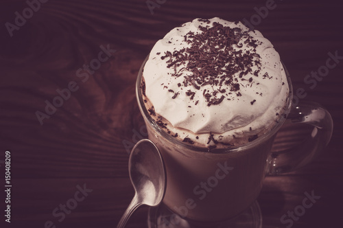 Hot viennese coffee with whipped cream on dark background
