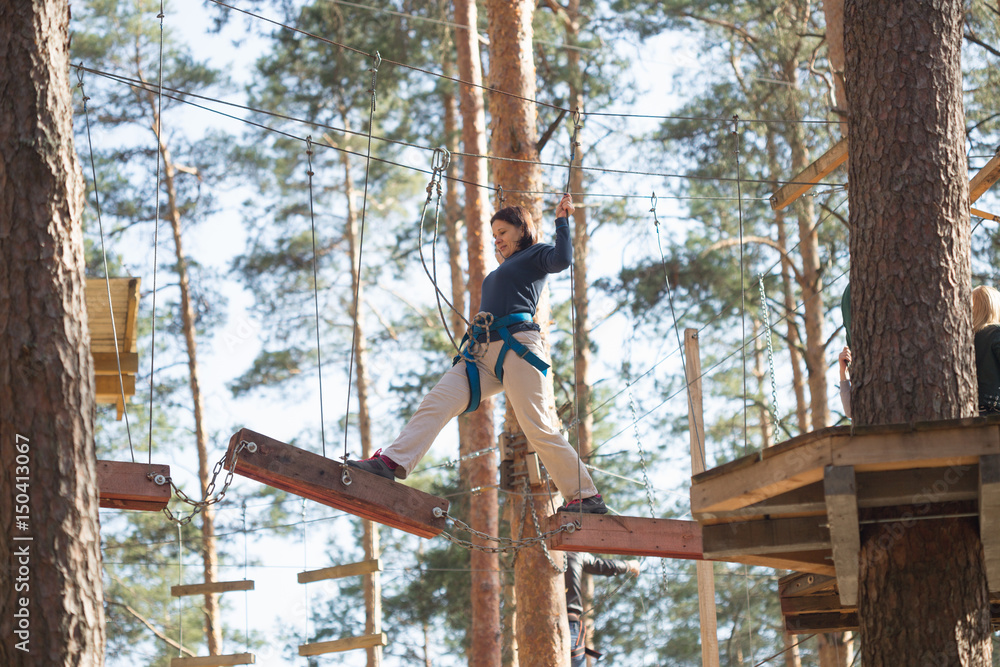 Gomel, Belarus - 30 April, 2017: Rope town for a family holiday in the countryside. Family competition to overcome aerial obstacles.
