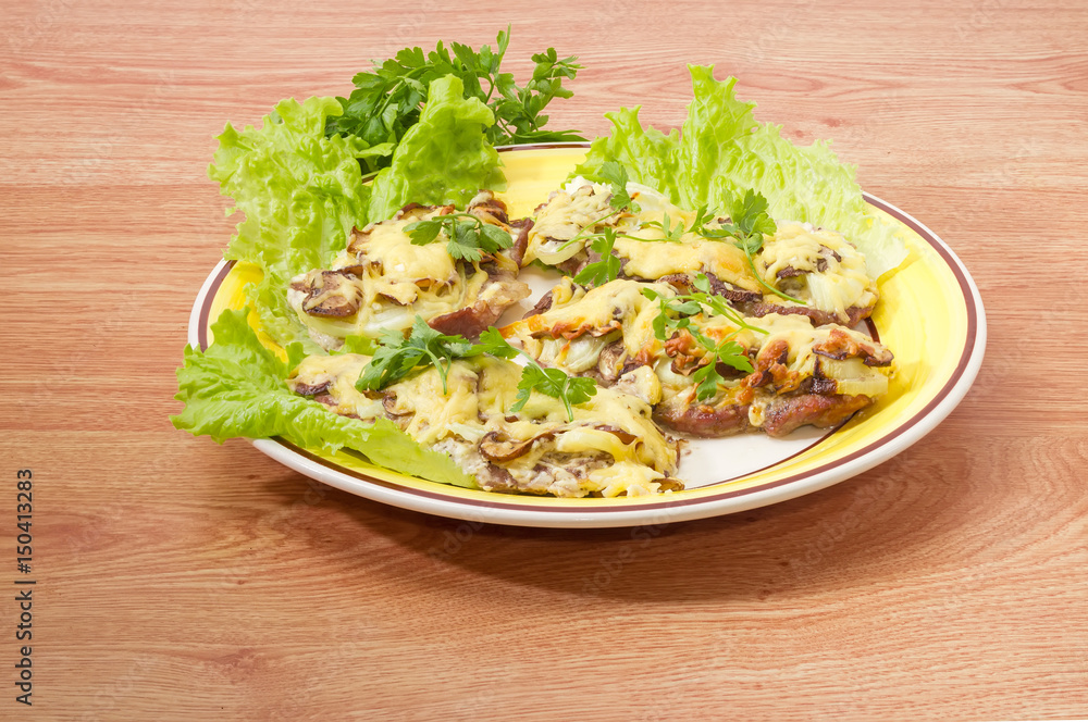 Pork chops baked with onion, mushrooms and cheese on dish Pork chops baked with onion, mushrooms and cheese on dish