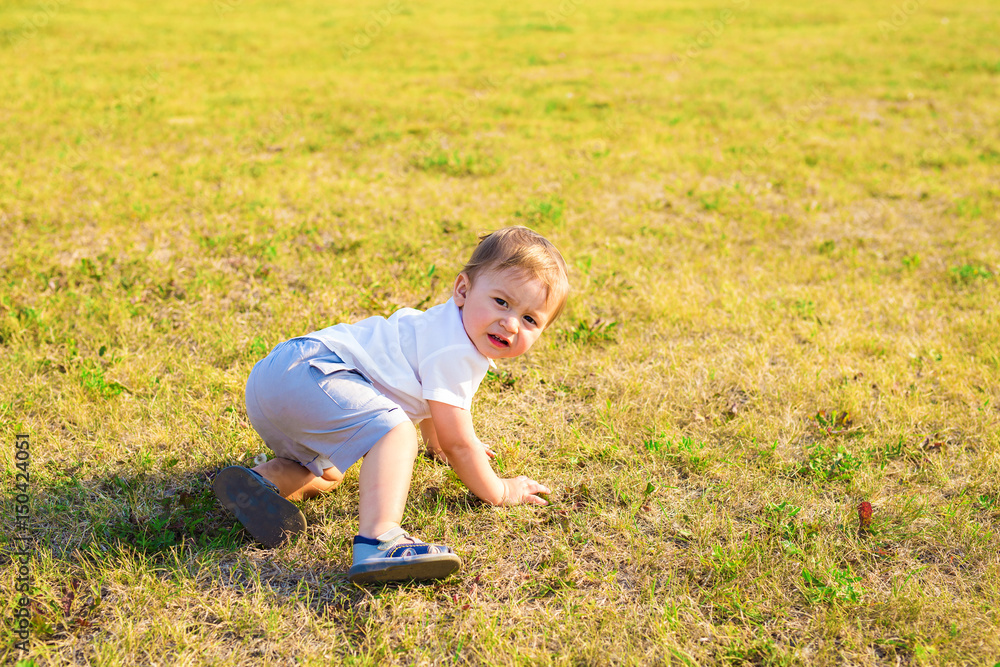 Happy laughing little boy playing in nature