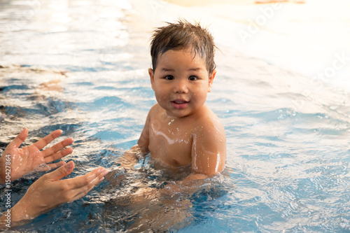 Portraits of happy children with swimming in a swimming pool.