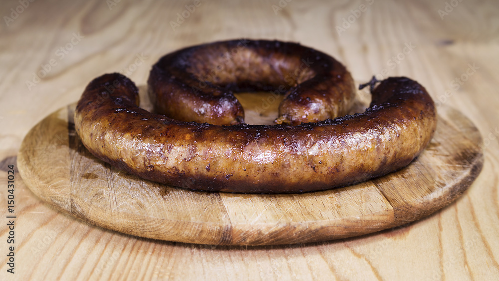 Fototapeta premium Fried Sausages On a Wooden Board