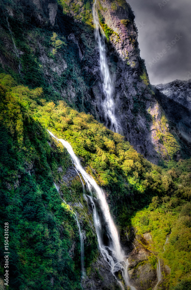 Twin Waterfalls flowing in Milford Sound Twin Waterfalls flowing in Milford Sound