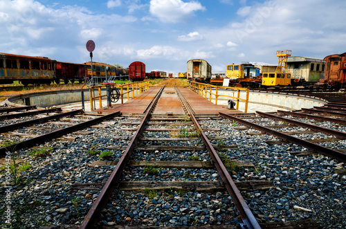 old train station deposit with railway turntable and rusty railcars photo