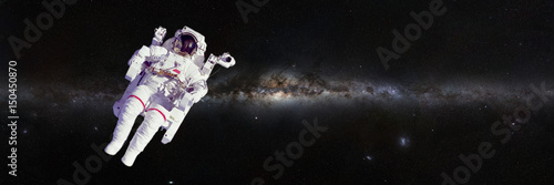 Astronaut in front of the beautiful Milky Way galaxy