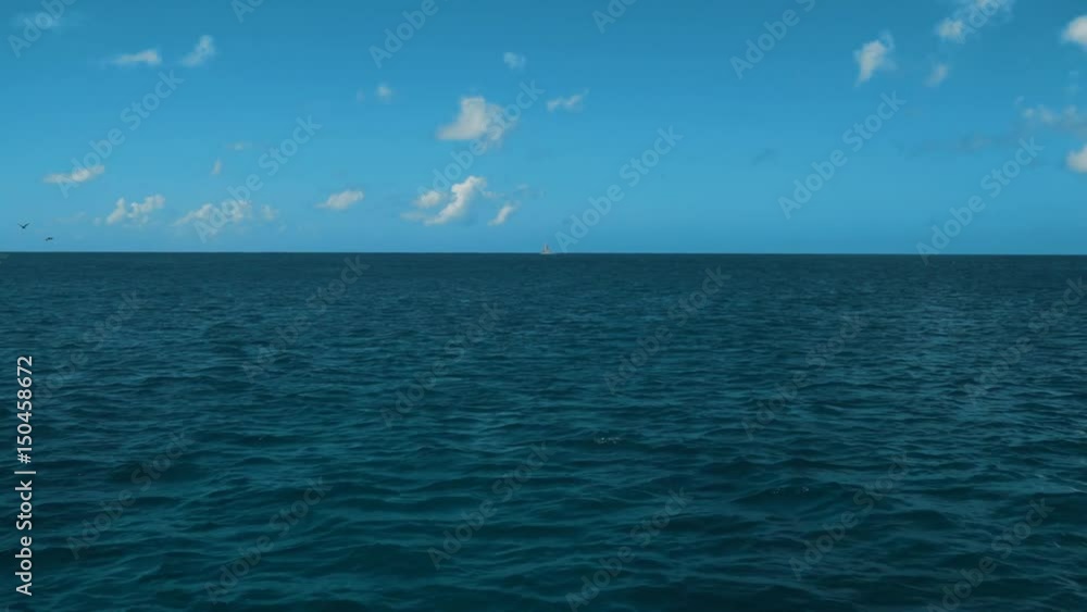 4k, uhd. A Wake From a Ship at Sea with Blue Ocean Water, a Horizon, Blue Sky and Clouds. Teal and orange style stabilizing camera. quite waves. Cruise travel. 4k, uhd. A Wake From a Ship at Sea with Blue Ocean Water, a Horizon, Blue Sky and Clouds. Teal and orange style stabilizing camera. quite waves. Cruise travel.