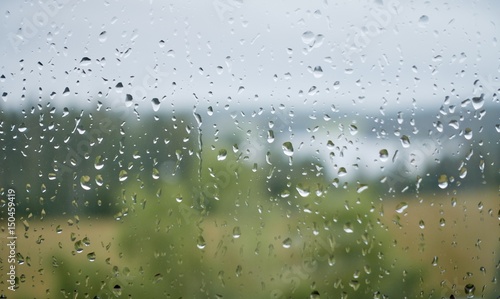 Water drops on wet window glass after the rain in summer