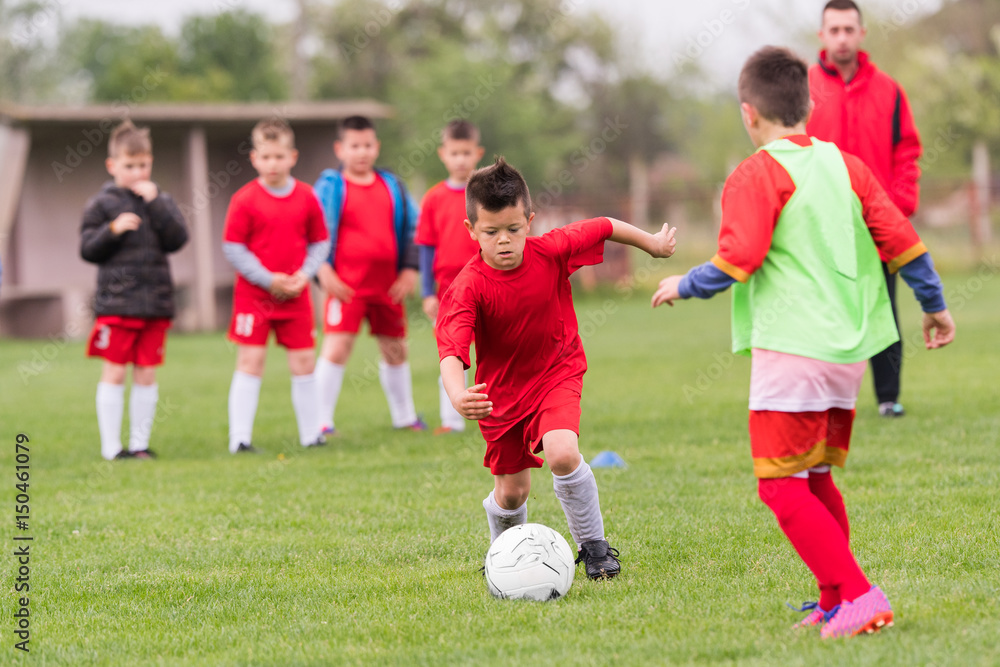 Kids soccer football - children players match on soccer field Kids soccer football - children players match on soccer field
