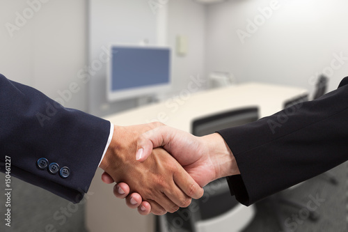 Bsuinessman hand shake in a meeeting room photo