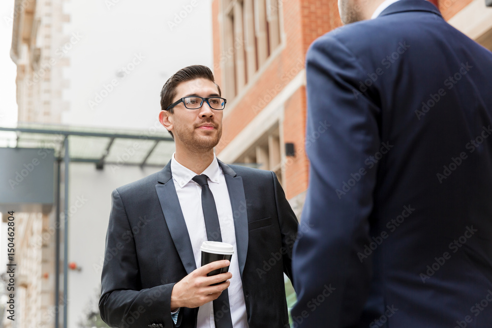 Fototapeta premium Two businessmen talking outdoors
