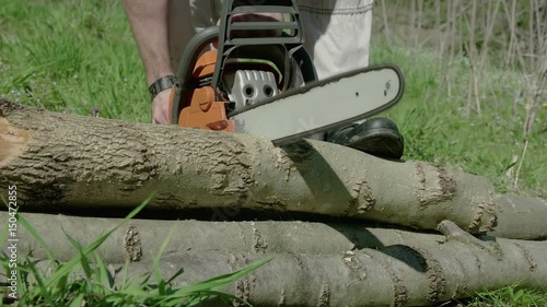 Red chainsaw sawn a timber