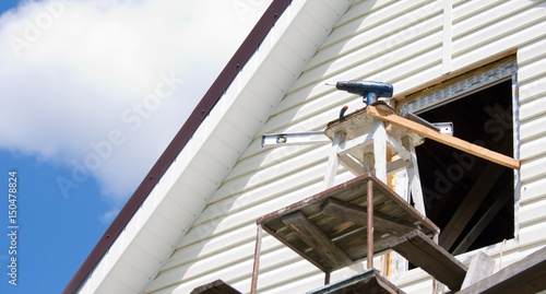 Installation of a siding on a house against the sky