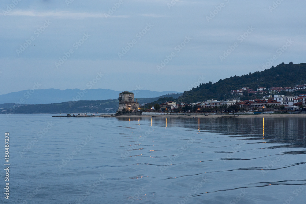 Fototapeta premium Beautiful coast of the Sea in Greece, in spring 2017. Seaside. A silhouette of a seaside city in the setting sun.