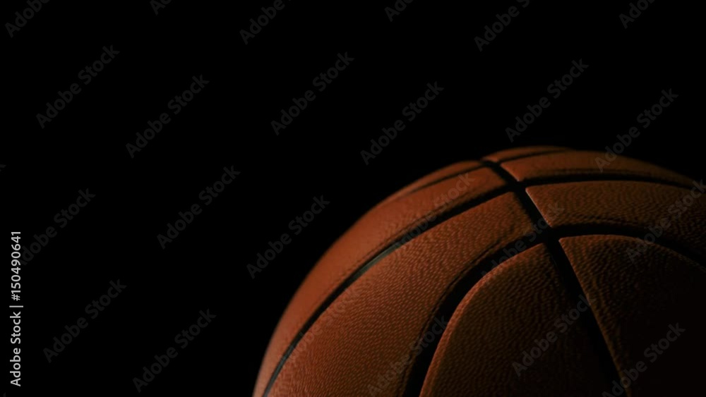 Basketball ball rolling on black background Basketball ball rolling on black background