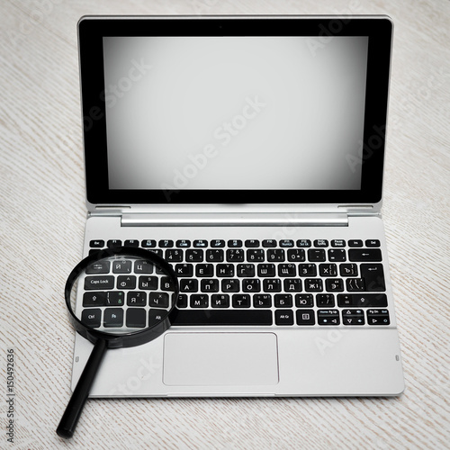 Laptop With Magnifying Glass.Close up