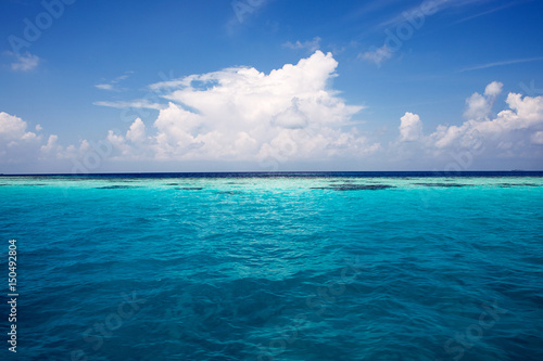 summer sea with blue water wave. Outdoor tropical summer sea paradise. Heaven view of deep transparent ocean. Sunshine reflection on a calm summer ocean. Tranquility of turquoise water