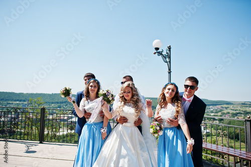 Wedding couple with bridesmaids on blue dresses and best mans having fun at wedding day. © AS Photo Family