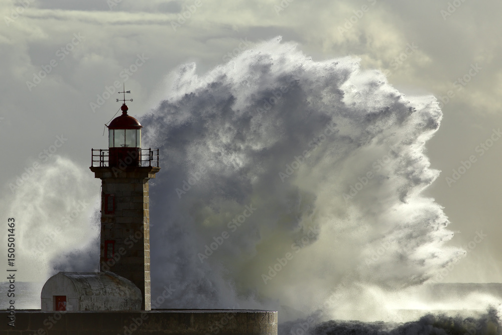 Stormy wave against lighthouse